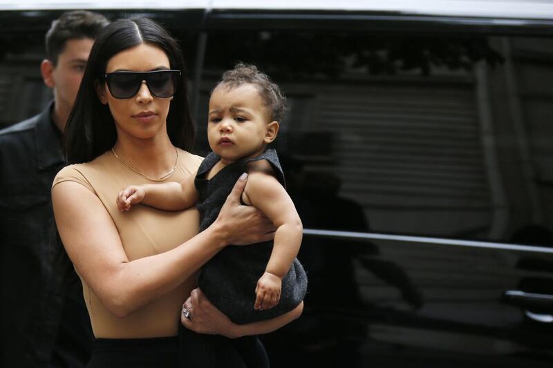 TV personality Kim Kardashian holds her daughter North in her arms as she shops in Paris on May 20, 2014. Kardashian and rapper Kanye West will celebrate their wedding in Florence on May 24, an official from the mayor’s office confirmed. Gonzalo Fuentes / Reuters 