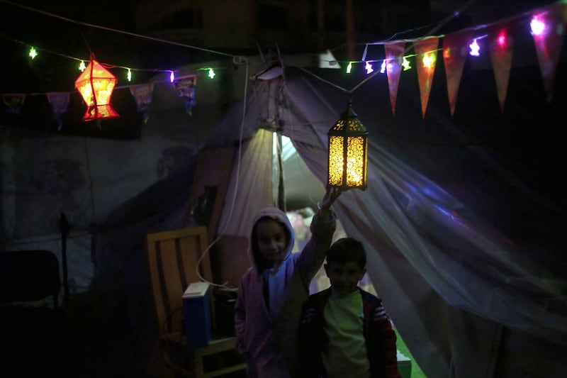 Displaced Palestinians in Rafah decorate their tent in preparation for Ramadan. Getty Images