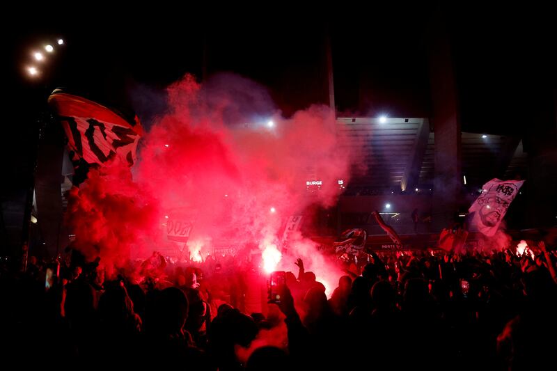 Flares are set off outside Parc des Princes after PSG win the Ligue 1 title. Reuters