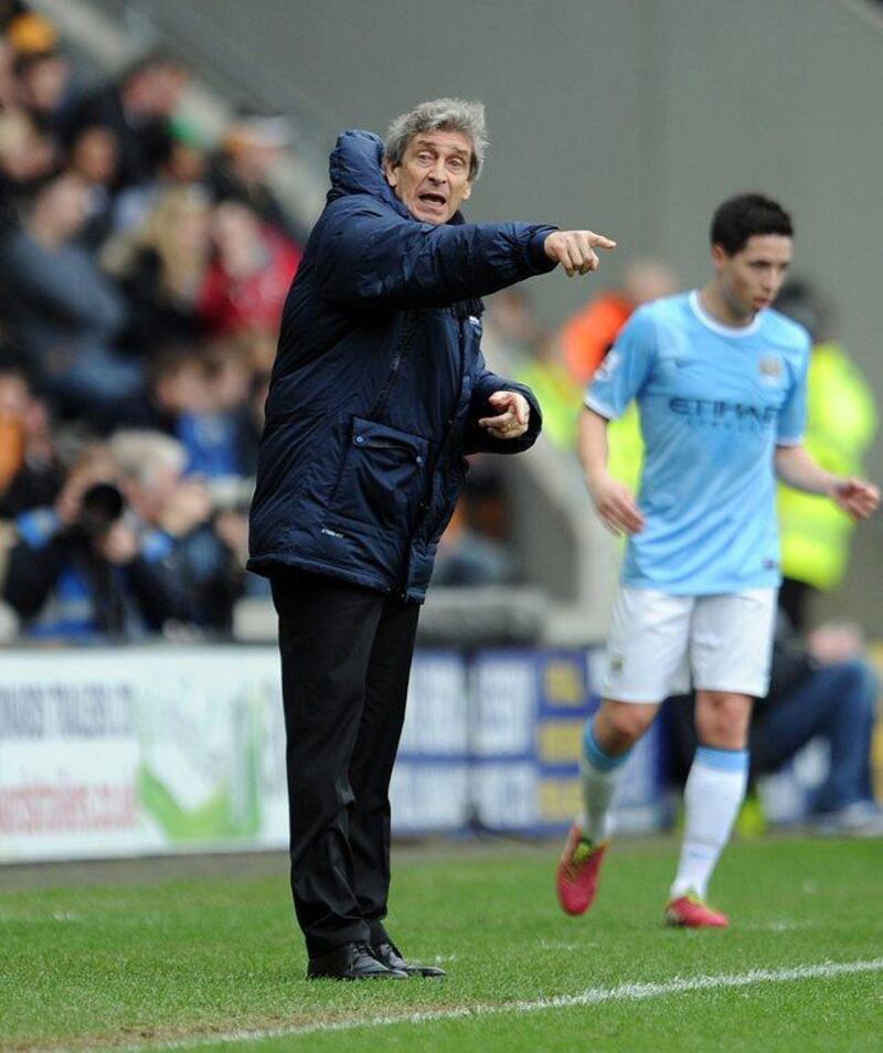 Manuel Pellegrini, left, manager of Manchester City gestures during the Premier League match between Hull City and Manchester City at the KC Stadium on March 15, 2014 in Hull, England. Clint Hughes/Getty Images