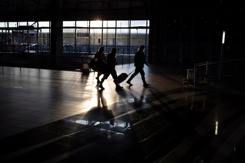 Passengers prepare to check in at a quiet OR Tambo International Airport. Many flights at the continent's busiest airport were cancelled amid the spread of the new variant. EPA