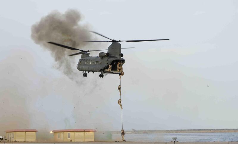 Officers take part in rope-fast drill during the military exercise.