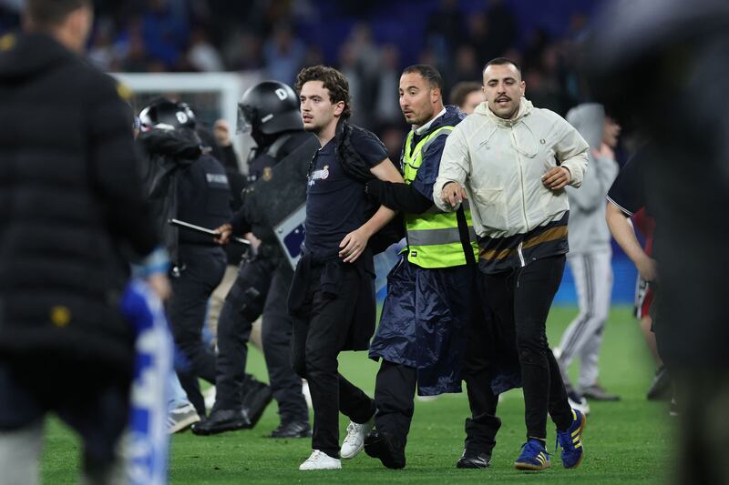 Espanyol fans react to Barcelona players celebrating on the pitch. AFP