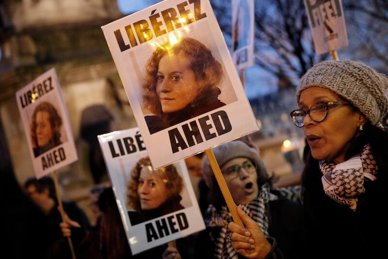 FILE - In this Jan. 4, 2018 file photo, demonstrators hold posters reading, "Release Ahed" during a protest demanding Israel to release Ahed Tamimi. Tamimi is to go on trial Tuesday, Feb. 13, 2018, before an Israeli military court, for slapping and punching two Israeli soldiers in December. Palestinians say her actions embody their David vs. Goliath struggle against a brutal military occupation, while Israel portrays them as a staged provocation meant to embarrass its military. Tamimi is one of an estimated 350 Palestinian minors in Israeli jails. (AP Photo/Christophe Ena, File)