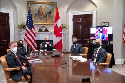 US President Joe Biden, with US Vice President Kamala Harris (2nd L), National Security Advisor Jake Sullivan (L), Secretary of State Antony Blinken (2nd R) and Deputy Assistant Secretary of State for Western Hemisphere Affairs Juan Gonzalez (R) hold a virtual bilateral meeting with Canadian Prime Minister Justin Trudeau (on screen) in the Roosevelt Room of the White House in Washington, DC, February 23, 2021. / AFP / SAUL LOEB

