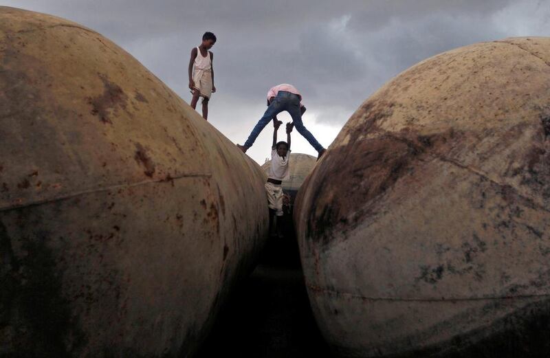 Children play on pontoons as clouds gather over the banks of the river Ganges in Allahabad.  Jitendra Prakash / Reuters