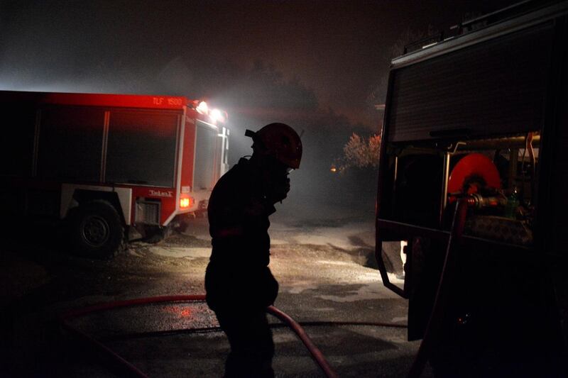 A firefighter tries to extinguish a fira at the Moria refugee camp on the northeastern Aegean island of Lesbos, Greece. AP Photo