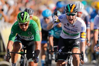 Ireland's Sam Bennett, right, celebrates as he crosses the finish line ahead of third place Slovakia's Peter Sagan, left, during stage 10 of the Tour de France cycling race over 168.5 kilometers (104.7 miles) from Ile d'Oleron to Ile de Re, France, Tuesday, Sept. 8, 2020. (AP Photo/Christophe Ena, Pool)