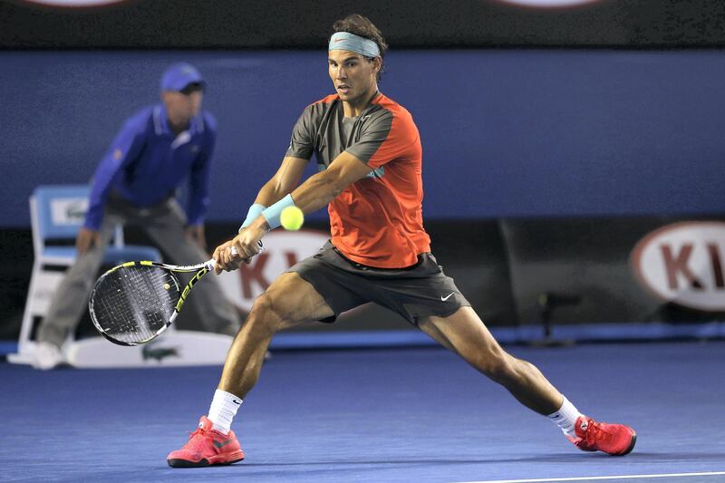 MELBOURNE, AUSTRALIA - JANUARY 26:  Rafael Nadal of Spain plays a backhand in his men's final match against Stanislas Wawrinka of Switzerland during day 14 of the 2014 Australian Open at Melbourne Park on January 26, 2014 in Melbourne, Australia.  (Photo by Clive Brunskill/Getty Images)