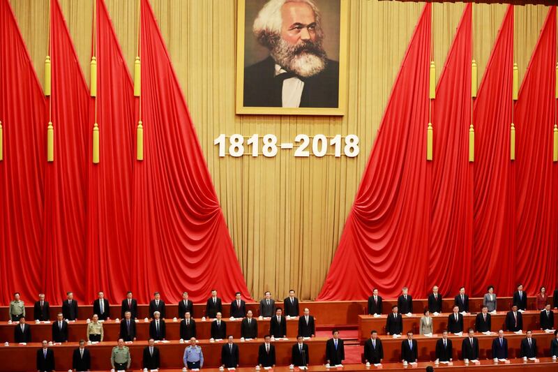 Chinese President Xi Jinping and attendees stand during an anniversary event celebrating the 200th year of the birth of Karl Marx at the Great Hall of the People in Beijing, China. Xi's speech came near the end of a week-long propaganda blitz by state media, with chat shows saying "Marx was Right" and cartoons of his wild youth aiming to show his theories remain relevant to modern China and the next generation. How Hwee Young / EPA