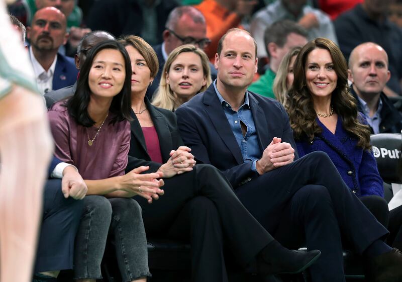 Ms Wu, Ms Healey and the Prince and Princess of Wales watch the game. AP