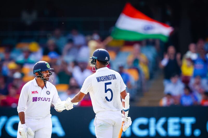 India's Washington Sundar (R) is congratulated by Shardul Thakur (L) after reaching his half century during day three of the fourth cricket Test match between Australia and India at the Gabba in Brisbane on January 17, 2021. -- IMAGE RESTRICTED TO EDITORIAL USE - STRICTLY NO COMMERCIAL USE --
 / AFP / Patrick HAMILTON / -- IMAGE RESTRICTED TO EDITORIAL USE - STRICTLY NO COMMERCIAL USE --
