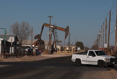 A pumpjack in a residential area pulls oil from the Permian Basin field in Texas. AFP
