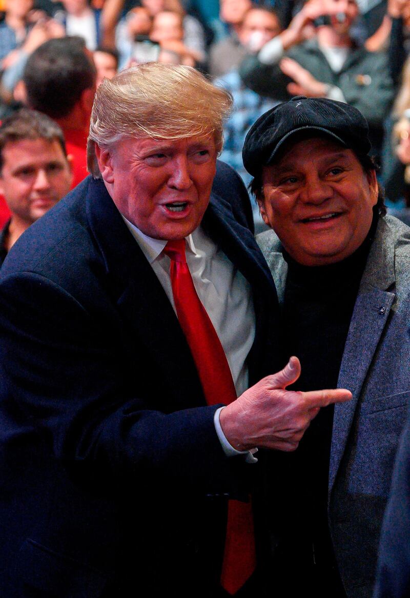 US President Donald Trump talks with former Panamanian boxer Roberto Duran as he arrives. AFP