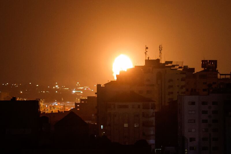 Smoke and flames rise above buildings after Israeli launched air strikes on Gaza city. AFP