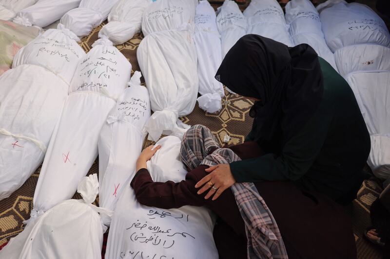 A woman cradles the body of her sister, killed in an Israeli bombardment in Rafah in the southern Gaza Strip. AFP