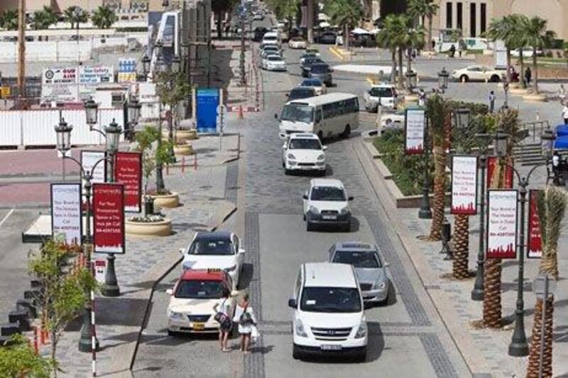 The Walk at Jumeirah Beach Residences is attracting fewer visitors, business owners say, because of traffic, paid parking and construction work blocking the view of the beach. Jaime Puebla / The National