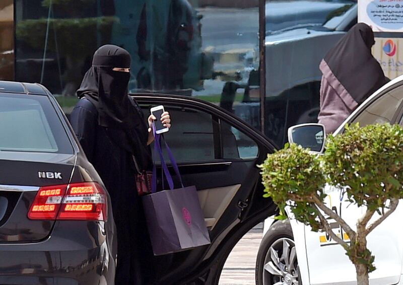A Saudi woman disembarks from a car outside a mall in the Saudi capital Riyadh on September 27, 2017.
Saudi Arabia will allow women to drive from next June, state media said on September 26, 2017 in a historic decision that makes the Gulf kingdom the last country in the world to permit women behind the wheel. 
The shock announcement comes after a years-long resistance from women's rights activists, some of whom were jailed for defying the ban on female driving. / AFP PHOTO / FAYEZ NURELDINE