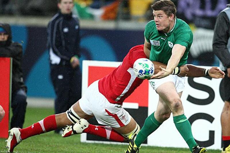 Brian O'Driscoll tries to offload the ball to an Ireland teammate in support as he is tackled by Toby Faletau during their quarter-final defeat to Wales.

Steve Haag/Gallo Images/Getty Images