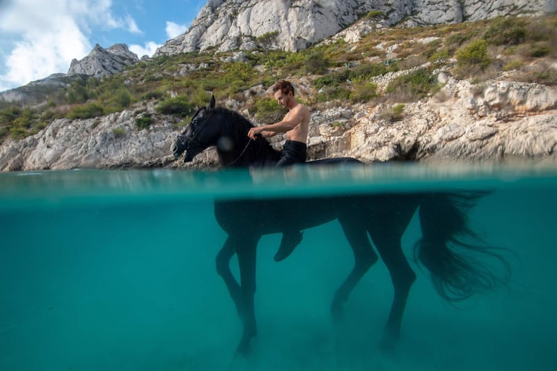 French artist Manolo trains his horse Indra to swim in the "Calanque of Sormiou" in Marseille. AFP