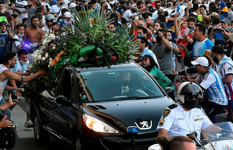 Fans next to the hearse carrying the late Diego Maradona in Buenos Aires. AFP