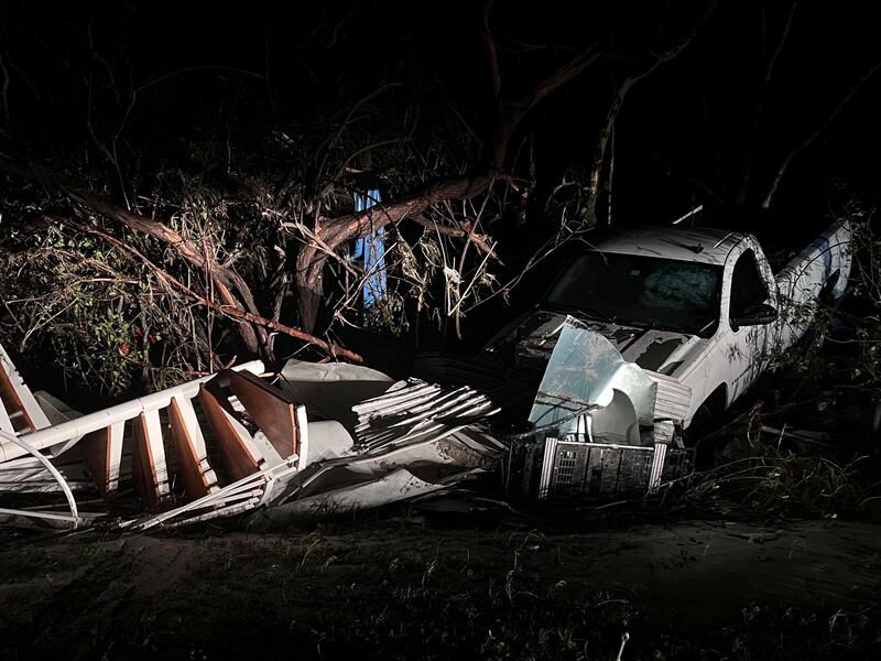 A spiral staircase and a white pick-up truck are deposited in brushland after Hurricane Ian passed through Sanibel, Florida. AP