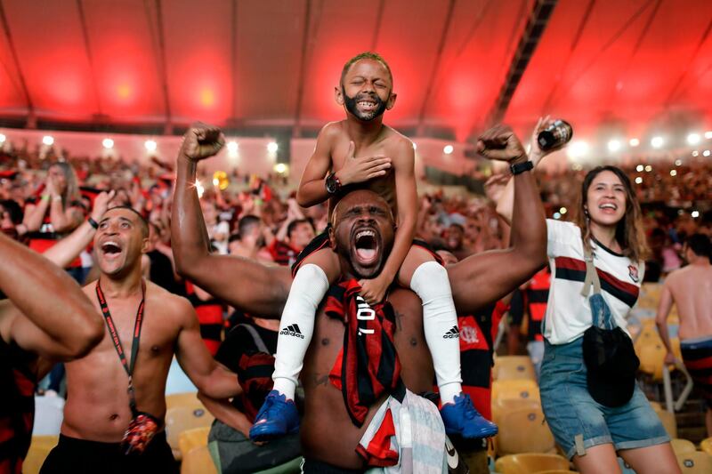 A photo by Silvia Izquierdo shows fans of Brazil's Flamengo football team cheer as Gabriel Barbosa scores a goal against defending champions River Plate of Argentina, in the final of the Copa Libertadores, broadcast on giant screens during a watch party at Maracana Stadium in Rio de Janeiro, Brazil, on November 23, 2019, wins second prize in the Sports Singles category. Silvia Izquierdo / AP Photo