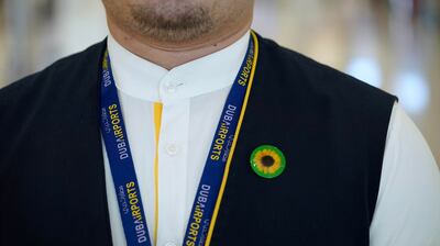 Dubai International Airport staff wear sunflower pins, an international symbol designed to raise awareness of hidden disabilities, to allow passengers to easily identify them. Photo: Dubai Airports