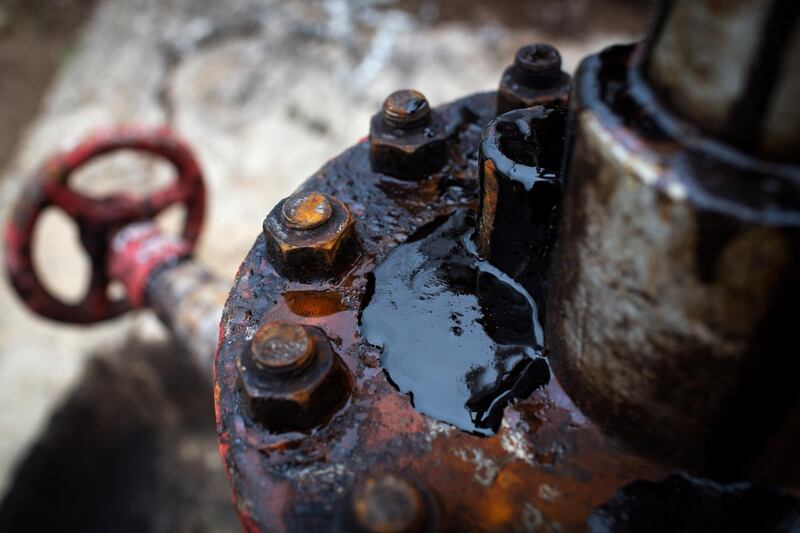 Thick black oil sits on the pipe work fitting of an oil pumping jack, also known as "nodding donkey" in an oilfield near Almetyevsk, Russia, on Sunday, Aug. 16, 2020. Oil fell below $42 a barrel in New York at the start of a week that will see OPEC+ gather to assess its supply deal as countries struggle to contain the virus that’s hurt economies and fuel demand globally. Photographer: Andrey Rudakov/Bloomberg