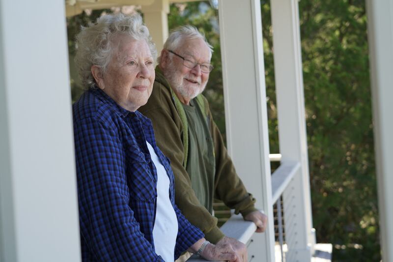 The Moores look out over their balcony to survey the damage caused by the storm. Willy Lowry / The National