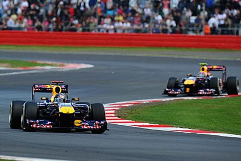 Sebastian Vettel leads Red Bull Racing teammate Mark Webber at the British Grand Prix. Webber was left unhappy after team orders told him to cool off his chase for second place.