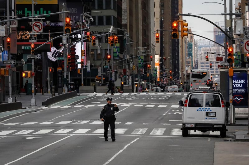A New York City Police officer (NYPD) takes a selfie while in the middle of the street in an almost empty Times Square, during the coronavirus disease (COVID-19) outbreak, in New York City, U.S. REUTERS