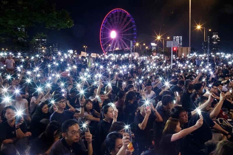 Demonstrators wave their smartphones during a rally ahead of the G20 summit in Hong Kong, China.  Reutrs