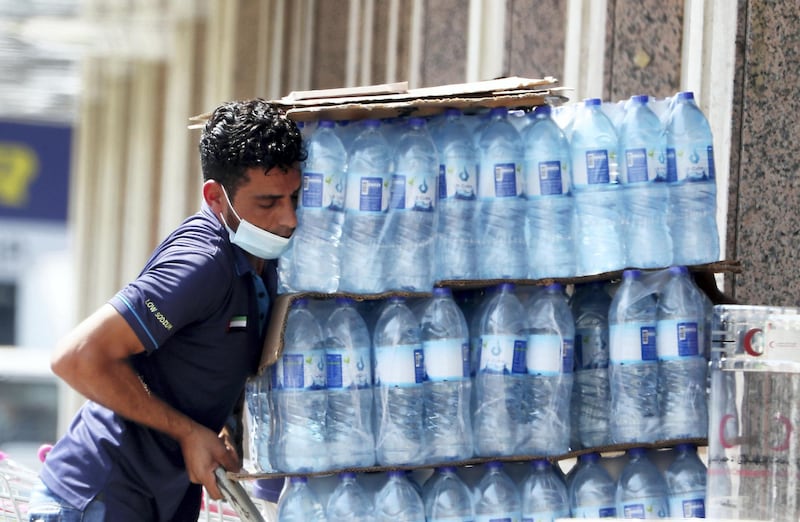 DUBAI, UNITED ARAB EMIRATES , October 3 – 2020 :- A worker wearing protective face mask as a preventive measure against the spread of coronavirus in Al Karama area in Dubai. (Pawan Singh / The National) For News/Stock/Online.