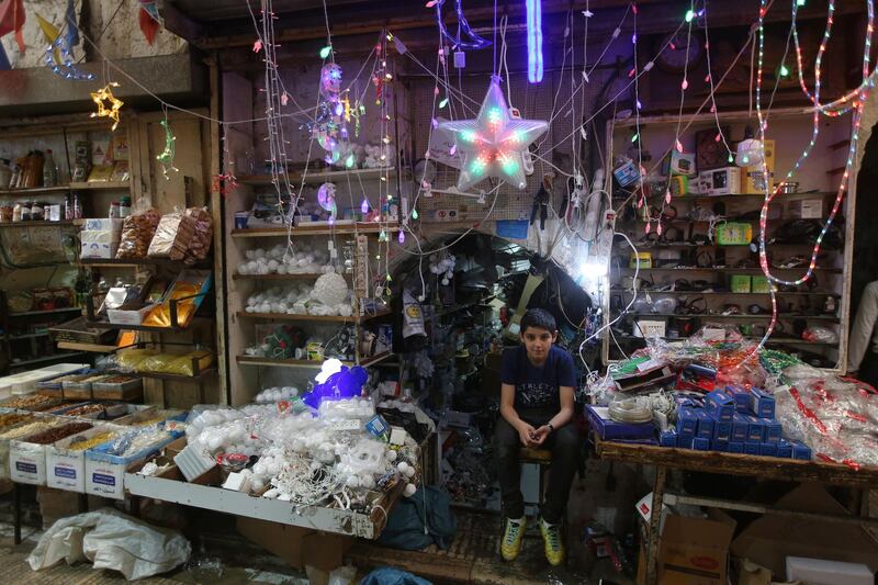 Palestinian vendor waits for customers during Ramadan, in the West Bank city of Nablus.  EPA