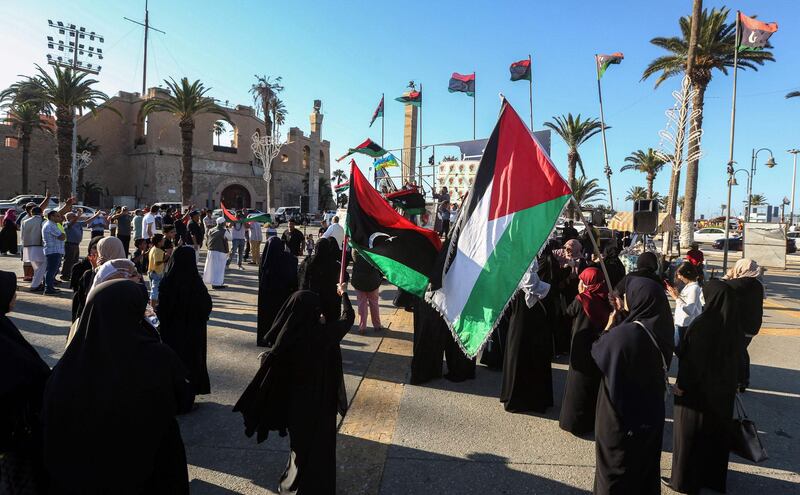 Women and children wave flags in the Martyrs' Square in the centre of the capital Tripoli, which is governed by the UN-recognised Government of National Accord.  AFP