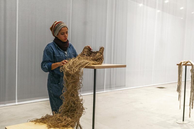 Afra Al Dhaheri working on her installation 'Tasreeha, 2020', from Abu Dhabi Art's Beyond: Emerging Artists show at Manarat Al Saadiyat