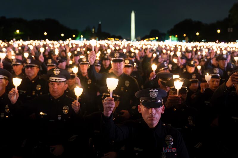 Policemen hold candles during the annual vigil to honour law enforcement officers who lost their lives in the line of duty,  in Washington. AP