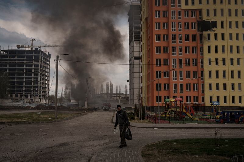 A man walks next to a fire after a Russian bombardment in Kharkiv, Ukraine. AP Photo