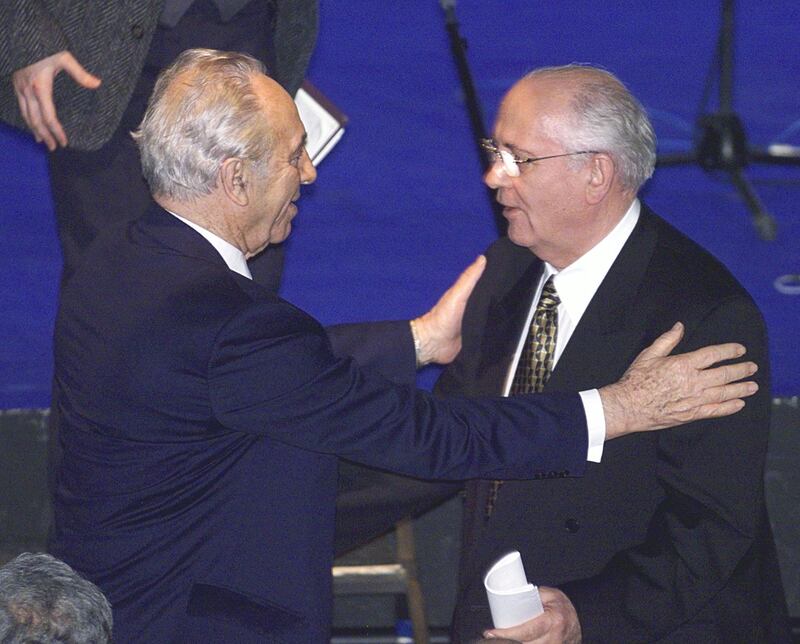 Former Soviet president Mr Gorbachev (right) is greeted by former Israeli prime minister Shimon Peres after the latter's speech to the second annual meeting of the board of the Peres Centre for Peace in Tel Aviv in January 1999. AFP