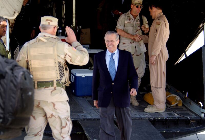 US Secretary of Defence Donald Rumsfeld (c) is saluted by US Army Lt Gen William Wallace as he arrives at Baghdad International Airport on April 30, 2003. Getty Images