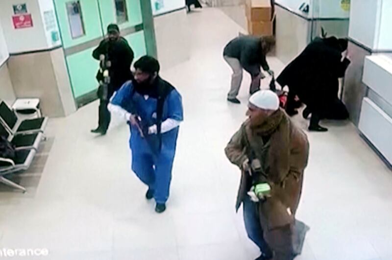 Israeli soldiers disguised as civilians and medical workers enter Ibn Sina Hospital in Jenin on Tuesday. AP