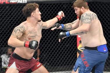 ABU DHABI, UNITED ARAB EMIRATES - JULY 26: (L-R) Tom Aspinall of England punches Jake Collier in their heavyweight fight during the UFC Fight Night event inside Flash Forum on UFC Fight Island on July 26, 2020 in Yas Island, Abu Dhabi, United Arab Emirates. (Photo by Jeff Bottari/Zuffa LLC via Getty Images)