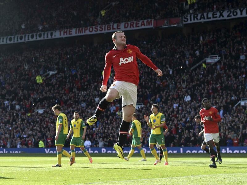 Manchester United's Wayne Rooney celebrates after scoring a second goal against Norwich during their English Premier League soccer match at Old Trafford in Manchester, northern England April 26, 2014. Nigel Roddis / Reuters