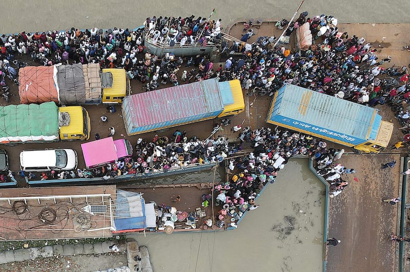 People board on a ferry as authorities ordered a new lockdown to contain the spread of the Covid-19 coronavirus, in Munshiganj. AFP