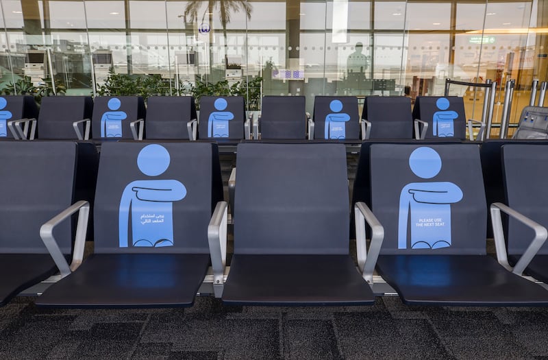 Signage encouraging social distancing on public seating in Abu Dhabi International Airport. Courtesy of Etihad Airways