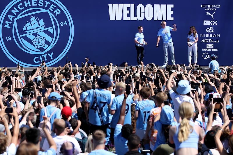 Erling Haaland waves to the fans during his Manchester City signing presentation at the Etihad Stadium on July 10, 2022. Getty