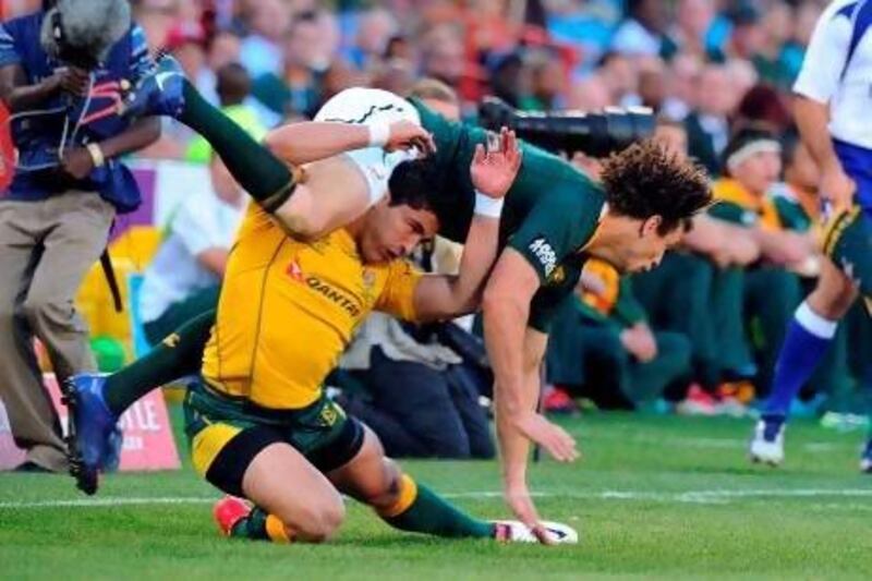 Australia’s Anthony Fainga’a tackles Zane Kirchner, one of South Africa’s try scorers, at Loftus Versfeld stadium in Pretoria yesterday.