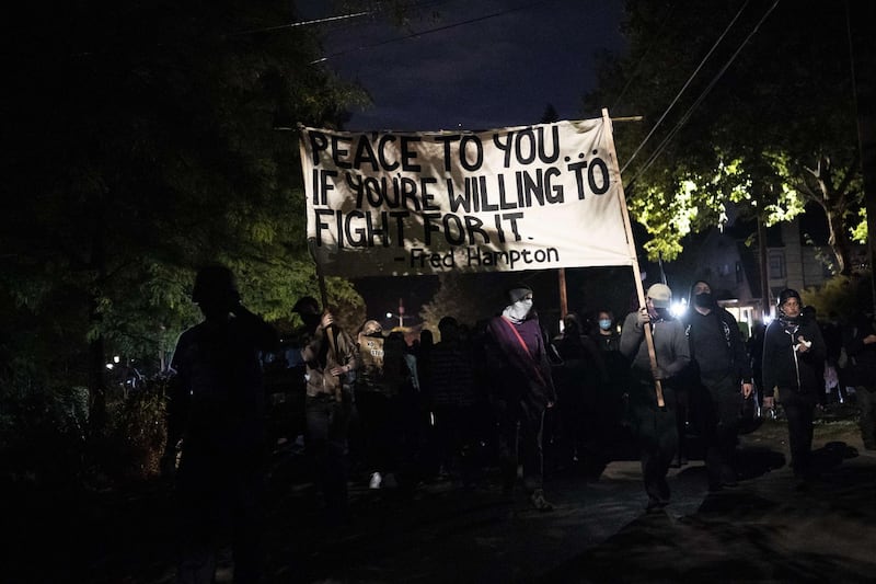 Anti-police protesters march toward the Portland east police precinct a day after political violence left one person dead in Portland, Oregon.  AFP
