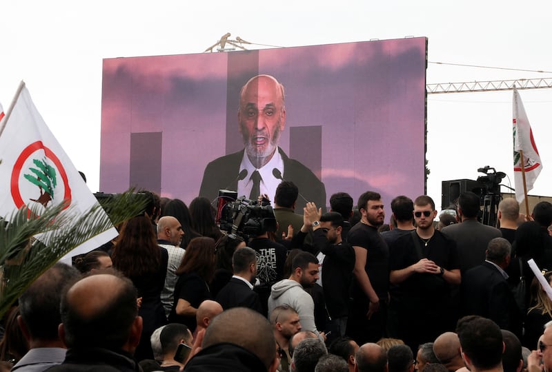 Samir Geagea, head of the Christian Lebanese Forces party, appears on a screen as he addresses his supporters at the funeral Mass for Mr Sleiman. Reuters